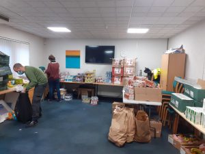 Ara Recovery For All support workers sort food parcels for supported housing clients
